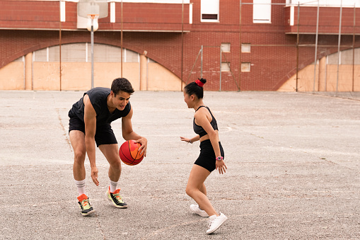 Chinese basketball player plays with her black-haired friend.