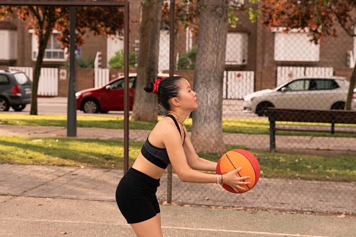 Chinese girl plays basketball during the summer