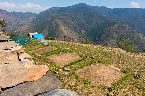 Campsite scars: Turf damage and footprints on grass after camping. Campsite on a hill top surround by Shivalik mountain range. Himalayan region in Uttarakhand . India