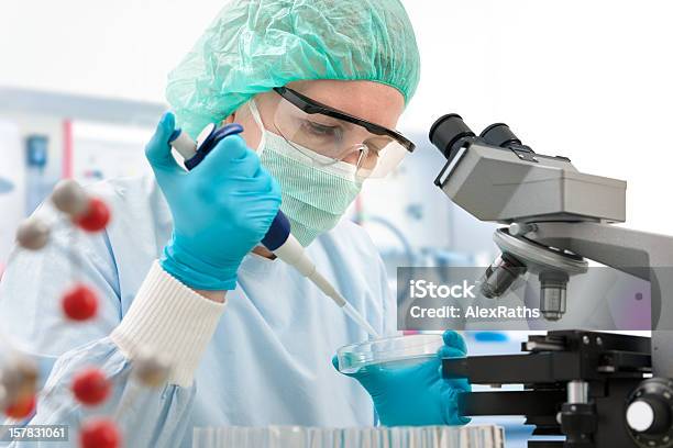 Woman In Laboratory Squeezing Liquid Into Petri Dish Stock Photo - Download Image Now