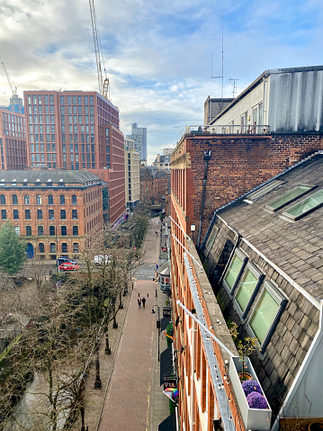 A rooftop view looking down Canal Street in Manchester, UK on a sunny day.