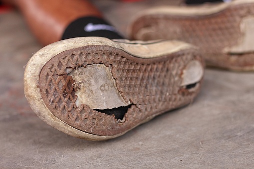 High angle view of lots of female shoes abandoned in the street in the city of Valencia, Spain