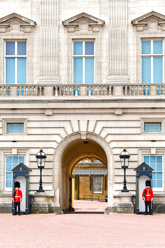 London, England, UK - 28 June 2023: Guardsmen standing to attention outside sentry boxes at Buckingham Palace in central London.