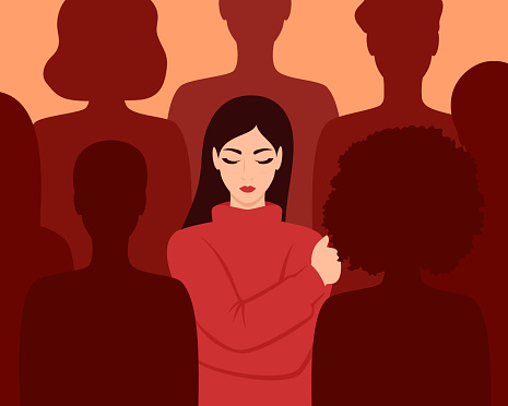 A woman hugging herself among the silhouettes of people. Loneliness in a crowd. Vector illustration in flat style