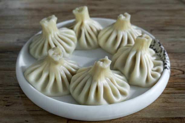 istock Khinkali with lamb on plate on wooden table 1578365627