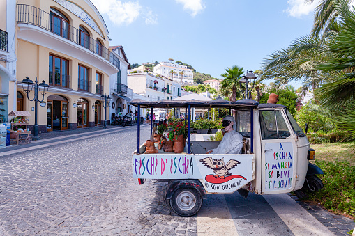 Casamicciola, Italy - July 27, 2023: Street in Casamicciola with ape car decorated for advertisment