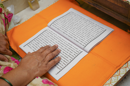 woman reading hindu religious book bhagavad gita