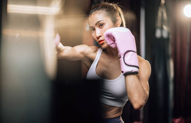 istock Kickboxing enthusiasts build strength, endurance, discipline, punch with power, movement, smash bags 1578448373