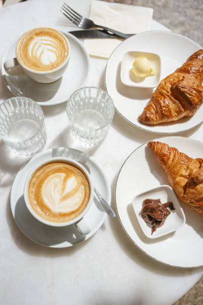 istock Breakfast at the cafe: coffee and croissants on the table 1578454210