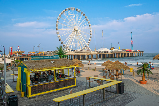 Atlantic City NJ, USA - July 18, 2023: The amusement pier and a beach bar in Atlantic City, New Jersey.