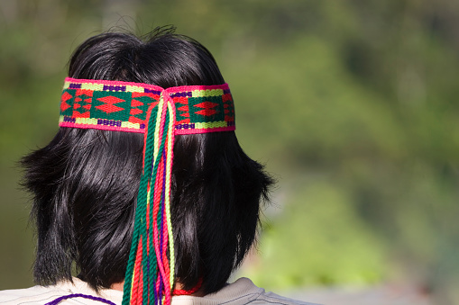 Pastasa Region, Ecuador - April 2, 2006: A local Achuar Tourist Guide wearing decorative head band in rainforest near the Pastasa River in South Sast Ecuador, South America
