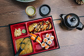 Bento box with sushi and miso soup on the table