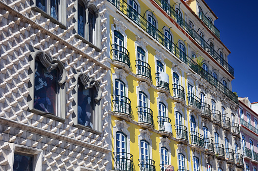 Low angle street view of the old train station of Aveiro covered in decorative blue tiles, Aveiro, Portugal. June 11, 2015.