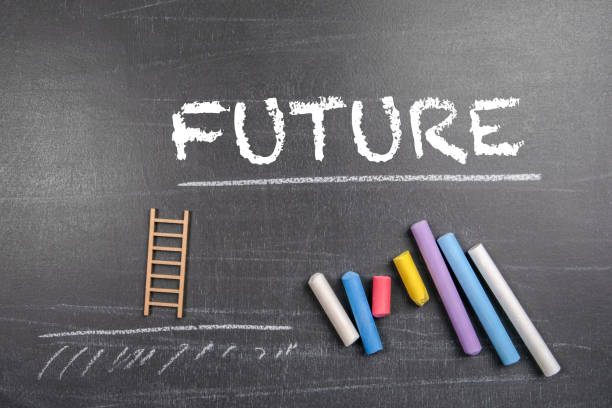 istock Future Concept. Colored pieces of chalk on a dark chalkboard background 1578503583
