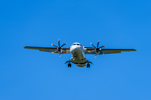 Low angle view of landing prop airplane against clear sky, Berlin Schönefeld