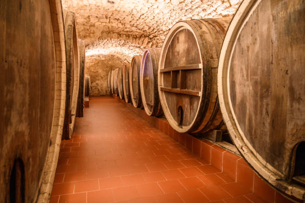 istock Vintage winery cellar with wine wooden barrels 1578545669