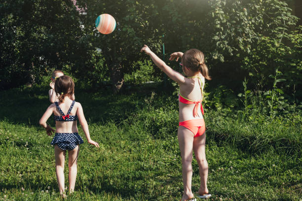 istock Children in a bathing suit throws an inflatable ball 1578546334