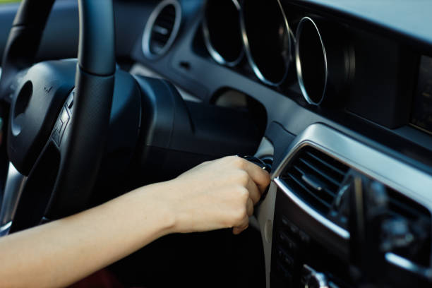 istock Young woman driver hands close up starts the engine with a key car 1578546464
