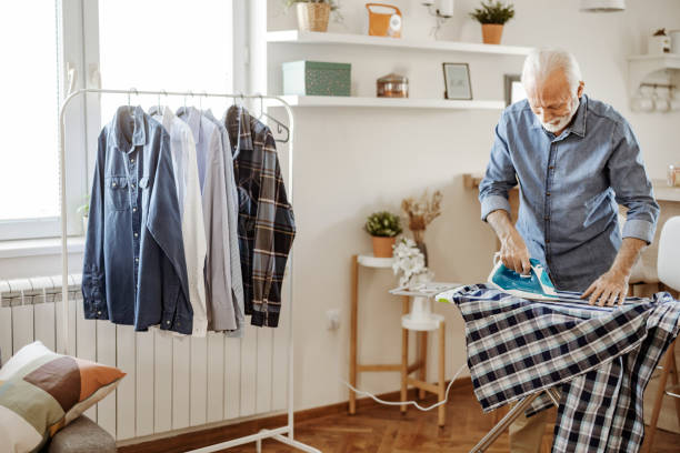 istock Senior Man Ironing Shirt 1578548983