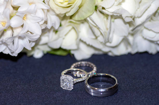 istock wedding rings and white flowers 1578549449