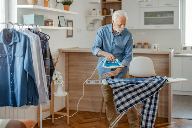 istock Senior Man Ironing Shirt 1578549504