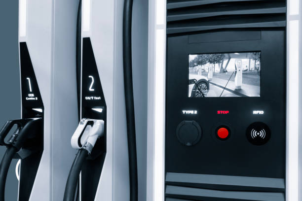 istock Electric car charging station for charge EV battery. Plug for vehicle with electric engine. EV charger. Clean energy. Charging point at car parking lot. Future transport technology. 1578551509