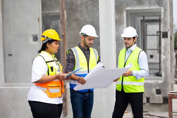 istock hispanic engineering man and fat female. Ethnic diversity worker people, Success teamwork. Group of professional engineering people wearing hardhat safety helmet meeting discussion in new project 1578552575