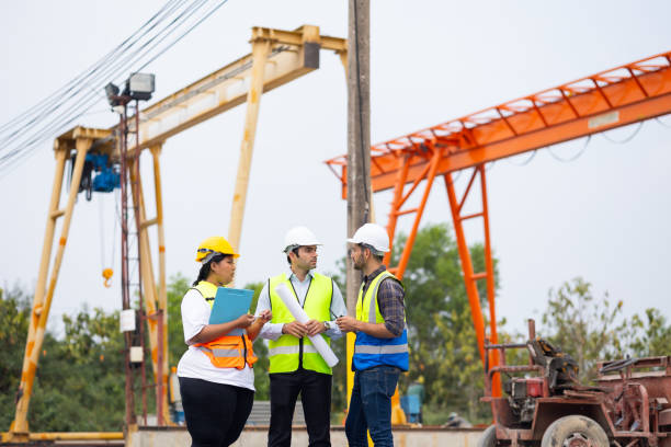 istock Obese female and hispanic male site engineers. Ethnic diversity worker people, Success teamwork professional engineering people in hardhat safety helmet meeting at Prefabricated concrete walls factory 1578552635