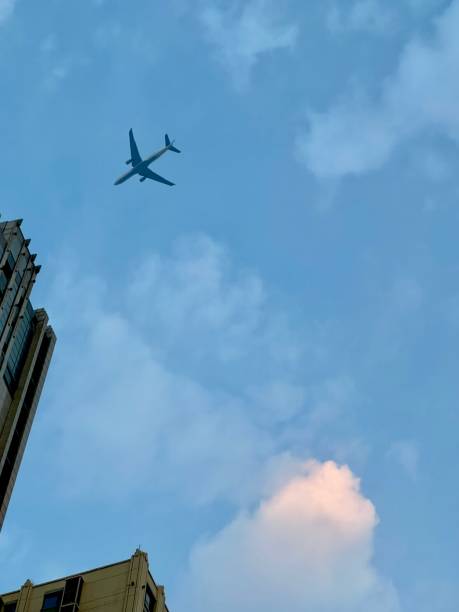 istock Airplane flying above the building 1578553501