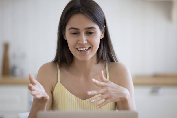 istock Cheerful student girl talking on video call at laptop 1578561306