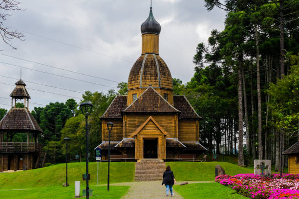 Ukrainian memorial with central church in Orthodox style with woman walking