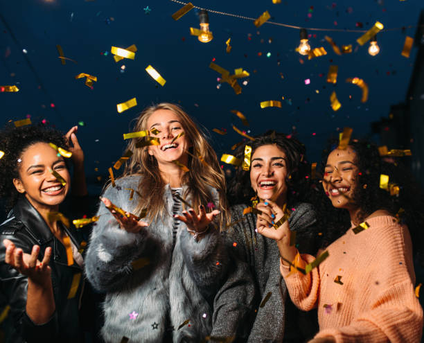 istock Group of four diverse friends laughing and having fun at night 1578662144