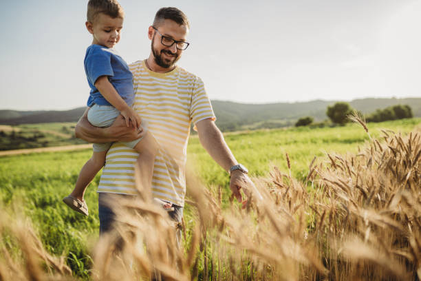 istock Father and son having fun on a wheat field 1578684093