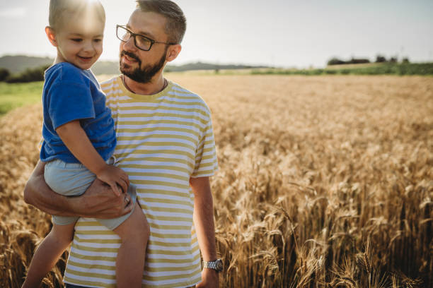 istock Father and son having fun on a wheat field 1578684110