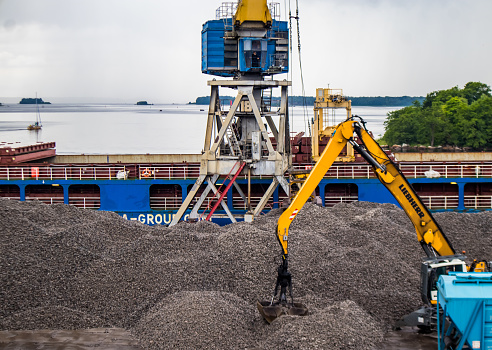 Russia, Vyborg - August 3, 2023: Loading rubble in the port using machinery
