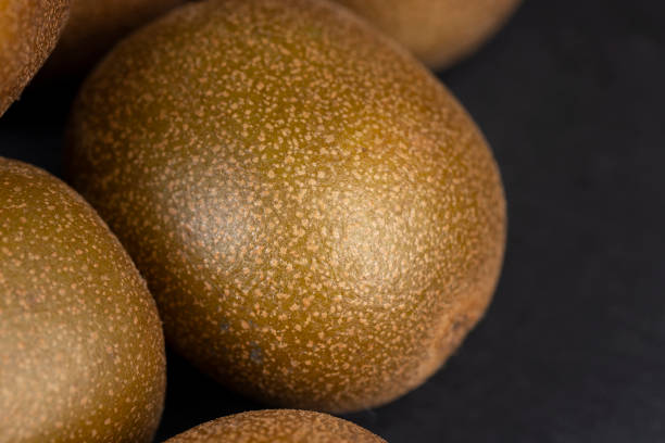 a group of ripe whole kiwis yellow, pure kiwis