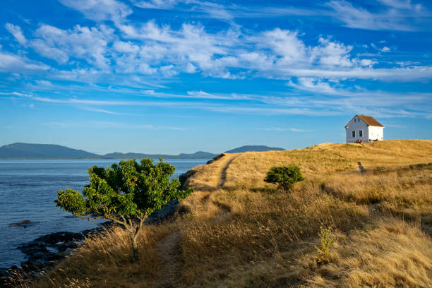 A view of Patos Island Light House at Alden Point in the Puget Sound with Mount Baker in distance.  A wonderful Pacific Northwest view in Washington State.