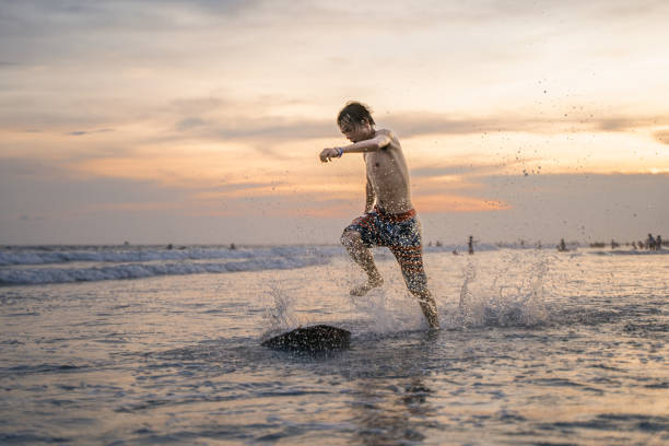 A teenager who is happy to surf by the sea
