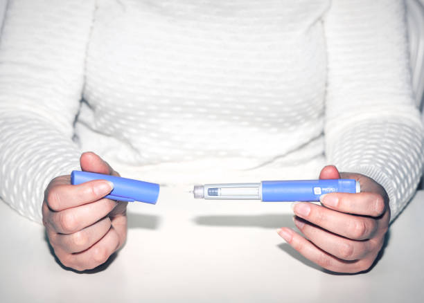 istock Woman holding an injection pen for diabetic. 1578816547