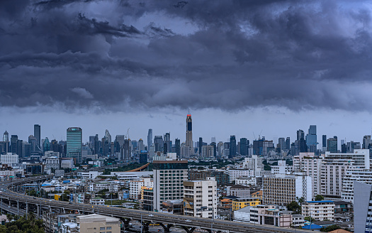 View city of Bangkok in Thailand before the storm in the twilight , rainy season thick clouds cover the town, global warming climate change concept