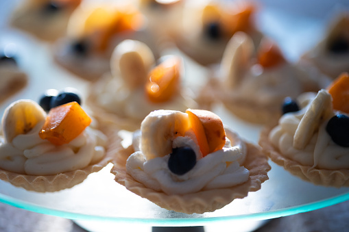 Tartlets with cream and fruits.