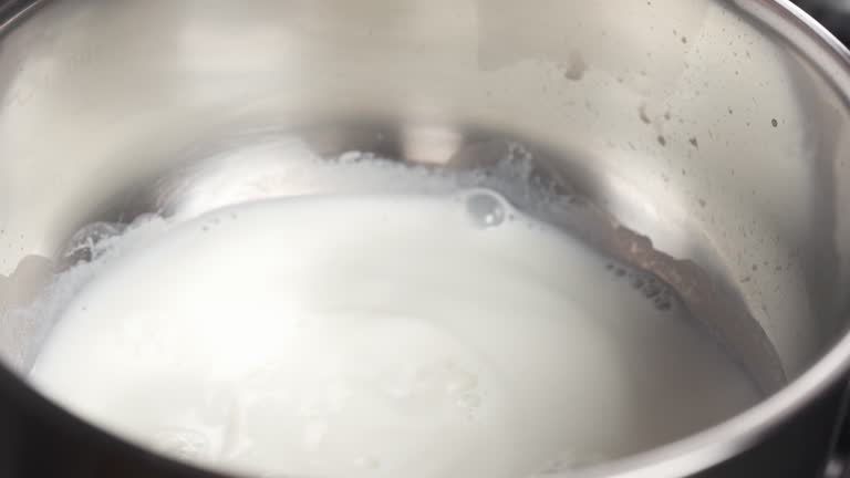 Slide shot of pouring milk into saucepan