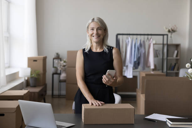 Happy Internet store manager packing cargo box for shipping
