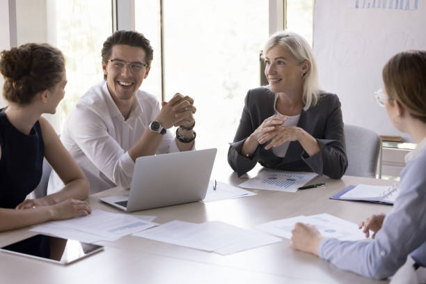 istock Cheerful business colleagues brainstorming at meeting table 1579013746