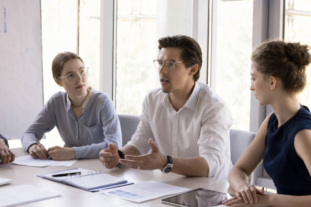 istock Business colleagues talking at office meeting, telling ideas 1579013953