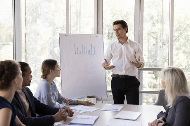 istock Confident business mentor giving marketing presentation, educating lecture, 1579014275