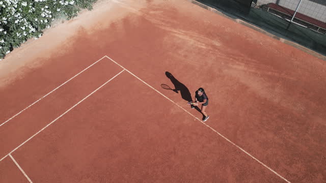 Professional tennis player training on a clay court