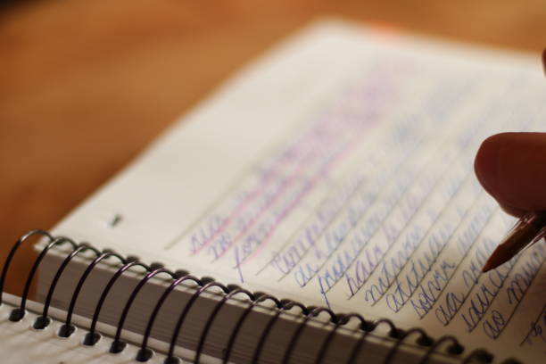 istock Person Writing in Notebook with Ballpoint Pen 1579066509