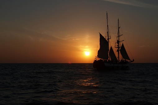 Sailing ship on the open sea at sunset off the Greek Islands