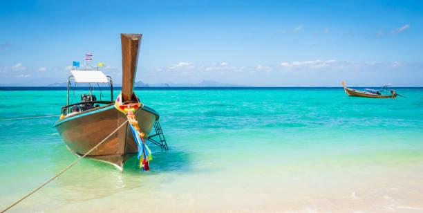 istock Traditional longtail boats near beautiful tropical island Ko Phi Phi, Thailand 1579110193